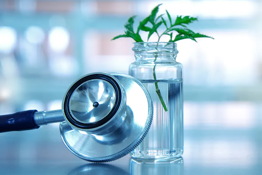 Close-up of a small vial with an herb inside and a stethoscope. Get treatment for medical conditions from Blue Skye Health and Wellness in Tampa.