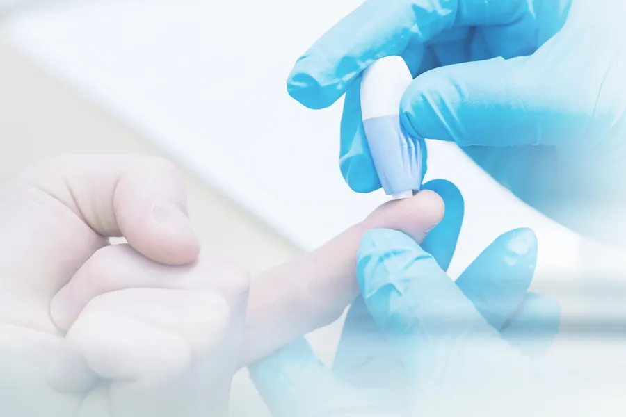 A doctor's gloved hand pricks a patients finger with to measure blood sugar, symbolizing diabetes treatment from Blue Skye Health and Wellness in Tampa.