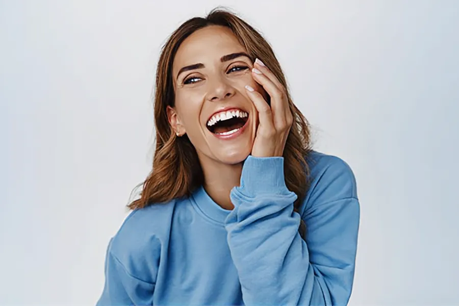 A middle-aged woman with healthy, glowing skin. Get GHK-Cu and Estradiol Facial Serum treatment from Blue Skye Health and Wellness in Tampa.