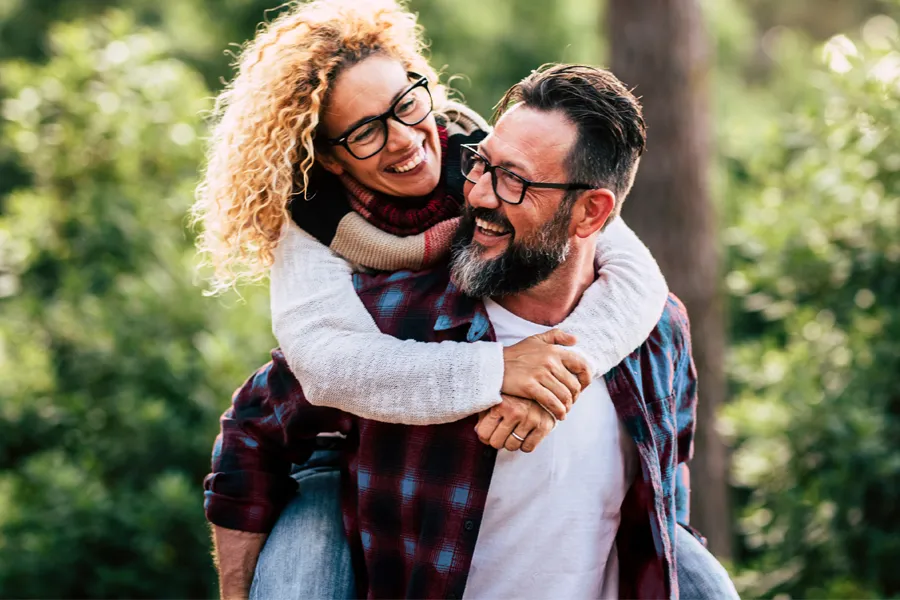 Happy middle-aged couple outdoors representing increased vitality and mental clarity from scheduling methylene blue therapy with Blue Skye Health and Wellness in Tampa.