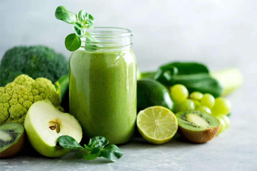 A tableau of healthy green fruits and vegetables and juices. Get nutritional counseling from Blue Skye Health and Wellness in Tampa.