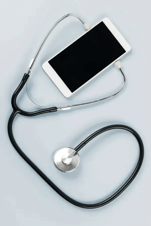 A smartphone with a stethoscope attached to it, symbolizing Telemedicine treatment from Blue Skye Health and Wellness in Tampa.